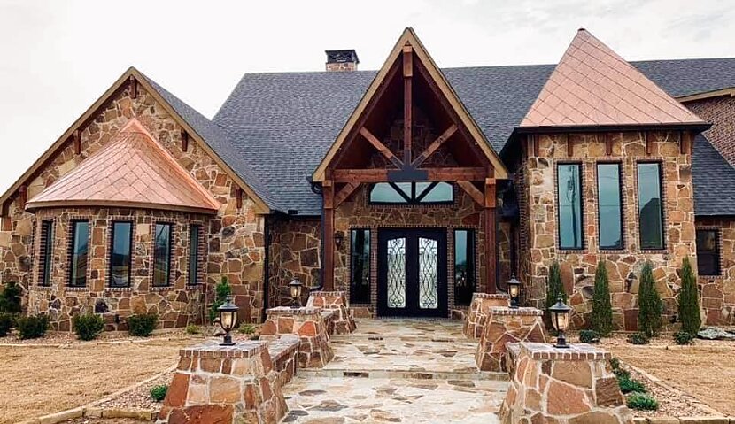 Custom home with full stone exterior — masonry by Mendoza
